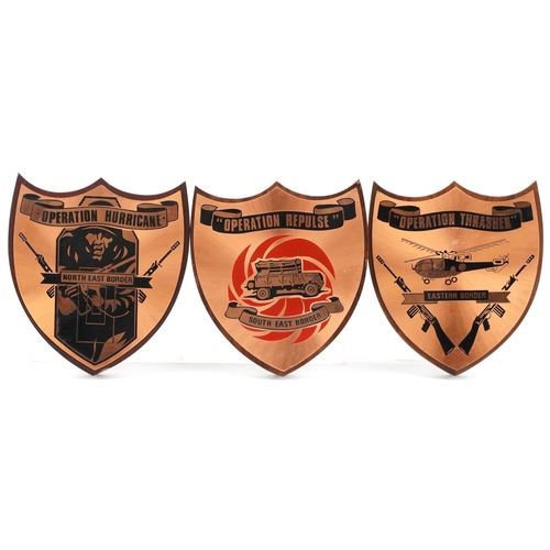 2479 - Four military interest South African coppered shields including Operation Hurricane North East Borde... 