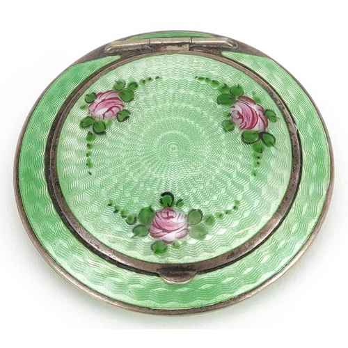  An Art Deco unmarked silver and green guilloche enamel compact, 5.5cm in diameter, 61.6g.