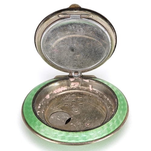  An Art Deco unmarked silver and green guilloche enamel compact, 5.5cm in diameter, 61.6g.