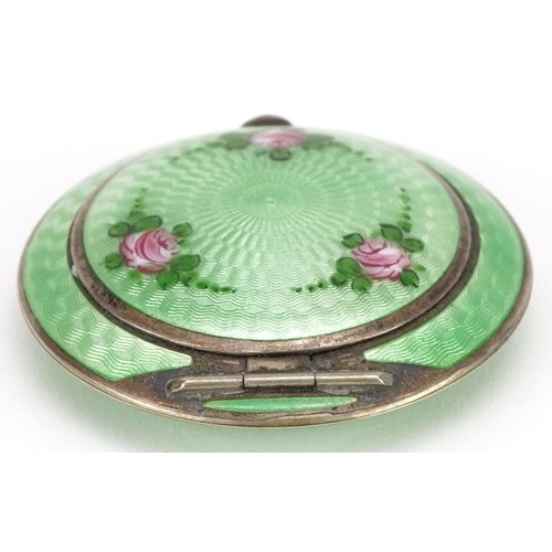  An Art Deco unmarked silver and green guilloche enamel compact, 5.5cm in diameter, 61.6g.