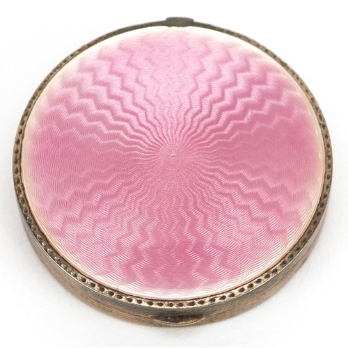 27 - Stockwell & Co., an Art Deco engine turned silver and pink guilloche enamel compact, London import m... 