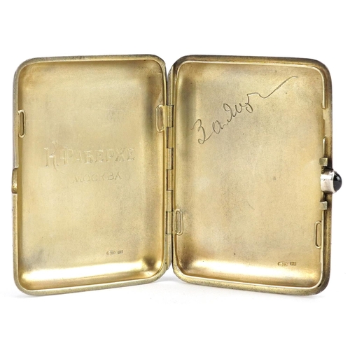  A Russian silver cigarette case with cabochon garnet push button and gilt interior, with inscription... 