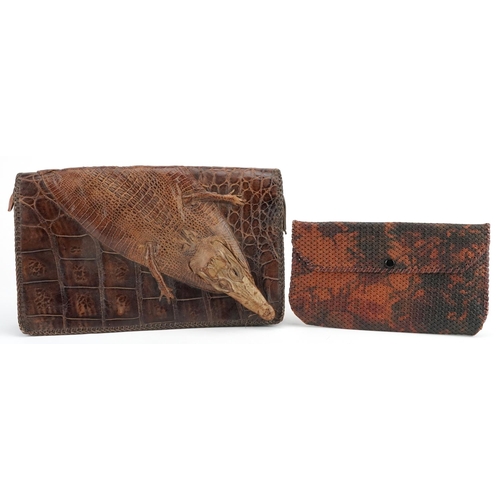 291 - An early 20th century crocodile skin clutch bag, 31cm wide, together with another clutch bag.