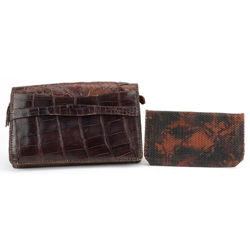 291 - An early 20th century crocodile skin clutch bag, 31cm wide, together with another clutch bag.