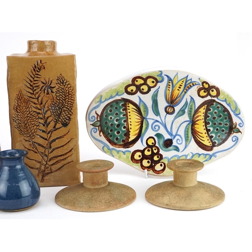 1175 - A small group of studio pottery items including two vases, a dish and a pair of candlesticks.