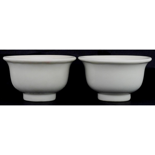 413 - A pair of Chinese porcelain white glazed footed bowls, 9cm in diameter.