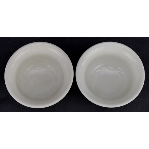 413 - A pair of Chinese porcelain white glazed footed bowls, 9cm in diameter.