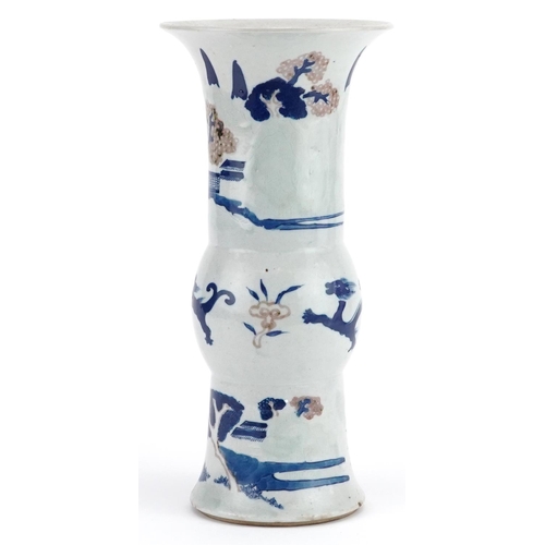 104 - A Chinese porcelain vase hand painted with dragons and pagodas beneath trees, 27cm high.