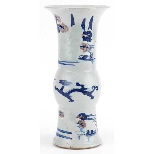 104 - A Chinese porcelain vase hand painted with dragons and pagodas beneath trees, 27cm high.