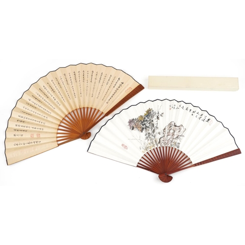 1218 - Two Chinese fans hand painted with flowers and script, 32.5cm in length when folded.