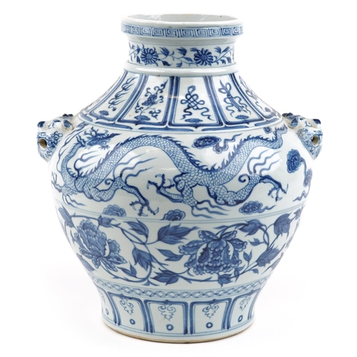 139 - A large Chinese porcelain blue and white vase with animal head handles and hand painted with dragons... 