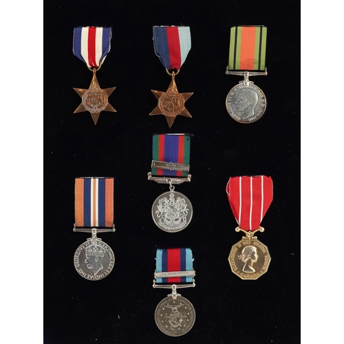 Seven British military World War II medals including Canadian Volunteer Service medal, Canadian Forces decoration awarded to LAC J.E.TOWNEND, Normandy Campaign medal numbered 6459 and The France and Germany star, framed and glazed.