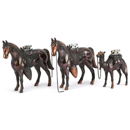 231 - Three bronzed spelter table lighters in the form of horses and a camel, the largest 19cm in length.