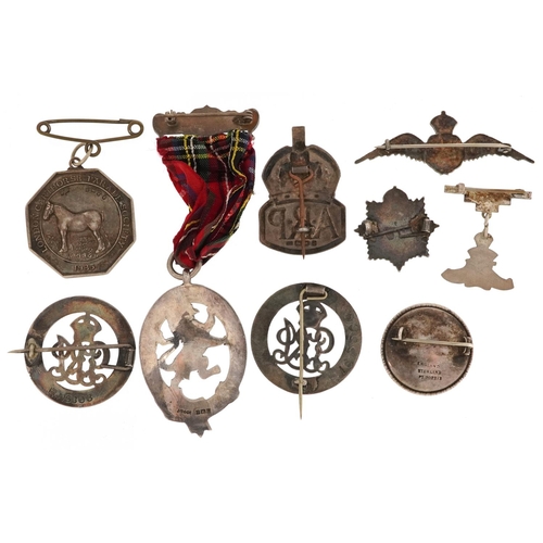  A collection of military interest silver badges and a Caledonian Society of London jewel, including ... 