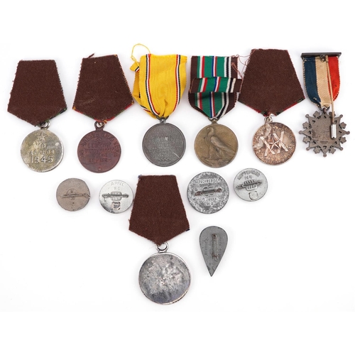 2413 - A collection of military interest medals and badges including European African Middle Eastern Campai... 