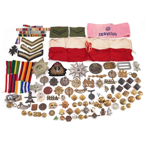 2453 - A large collection of British militaria including cap badges, buttons, arm bands and cloth patches.