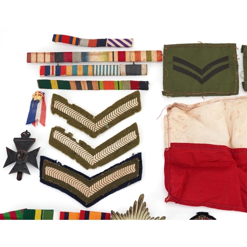 2453 - A large collection of British militaria including cap badges, buttons, arm bands and cloth patches.