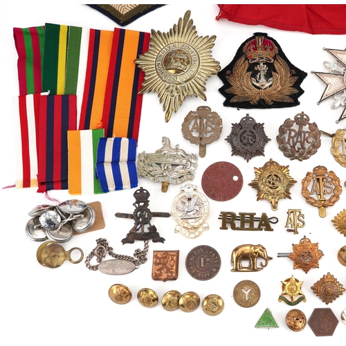 2453 - A large collection of British militaria including cap badges, buttons, arm bands and cloth patches.