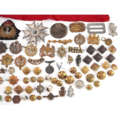 2453 - A large collection of British militaria including cap badges, buttons, arm bands and cloth patches.