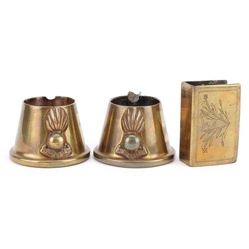 2468 - A pair of trench art brass shell case ashtrays and a matchbox holder.