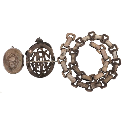 3771 - A Victorian aesthetic unmarked silver brooch together with an engraved locket and necklace, total we... 