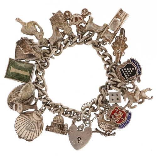 3662 - A silver charm bracelet with a collection of mostly silver charms including an emergency one pound n... 