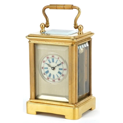 184 - A miniature brass cased carriage clock with swing handle, 8cm high.