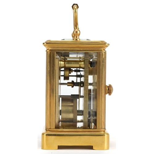 184 - A miniature brass cased carriage clock with swing handle, 8cm high.