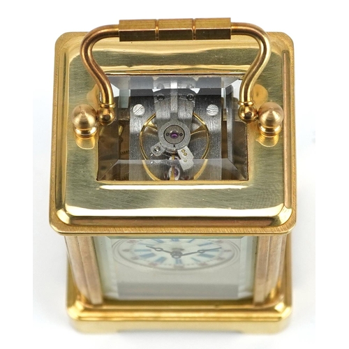 184 - A miniature brass cased carriage clock with swing handle, 8cm high.