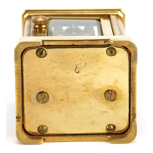 184 - A miniature brass cased carriage clock with swing handle, 8cm high.