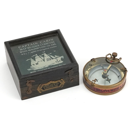 2473 - A naval interest brass compass housed in a wooden case, 8cm in diameter.