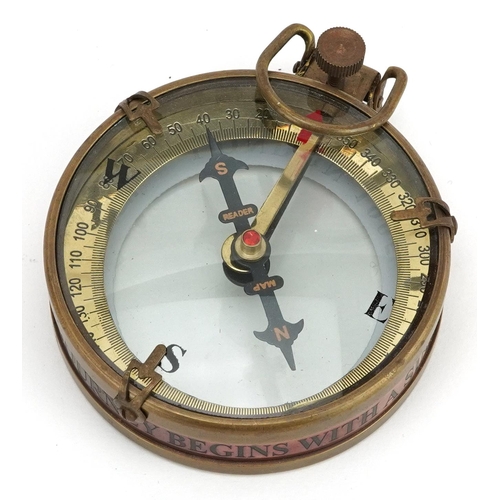 2473 - A naval interest brass compass housed in a wooden case, 8cm in diameter.