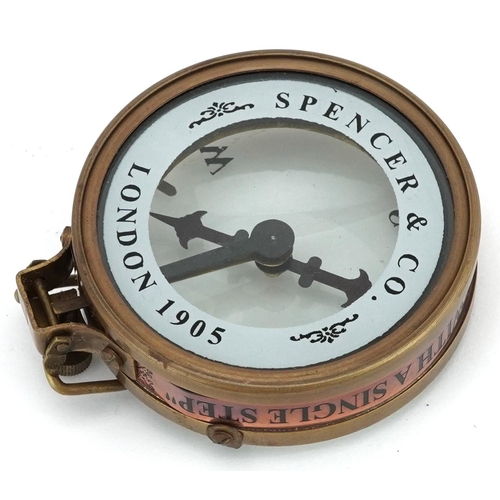 2473 - A naval interest brass compass housed in a wooden case, 8cm in diameter.