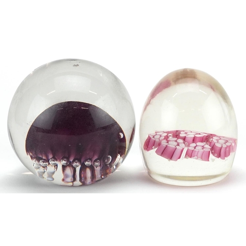 483 - A mid 20th century glass paperweight by Langham Glass House, 8cm in diameter, together with a simila... 