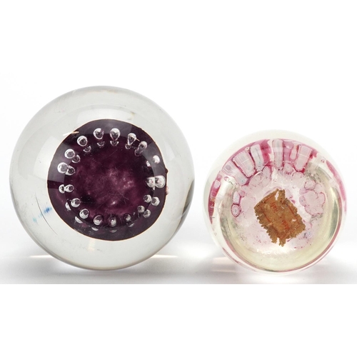 483 - A mid 20th century glass paperweight by Langham Glass House, 8cm in diameter, together with a simila... 