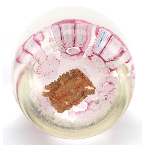 483 - A mid 20th century glass paperweight by Langham Glass House, 8cm in diameter, together with a simila... 