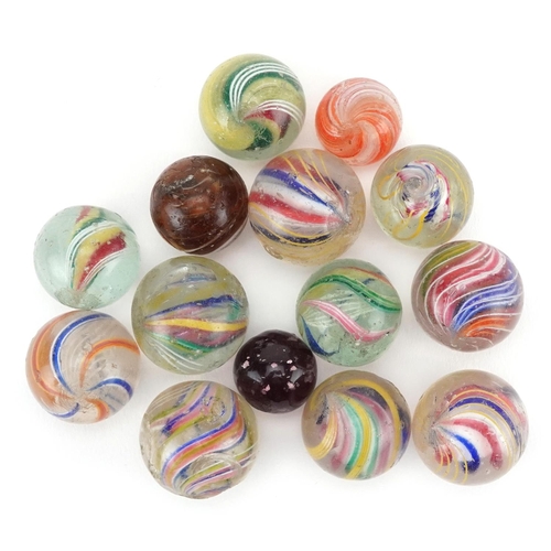 1318 - A collection of fourteen glass marbles, the majority with latticino swirls, variously sized.