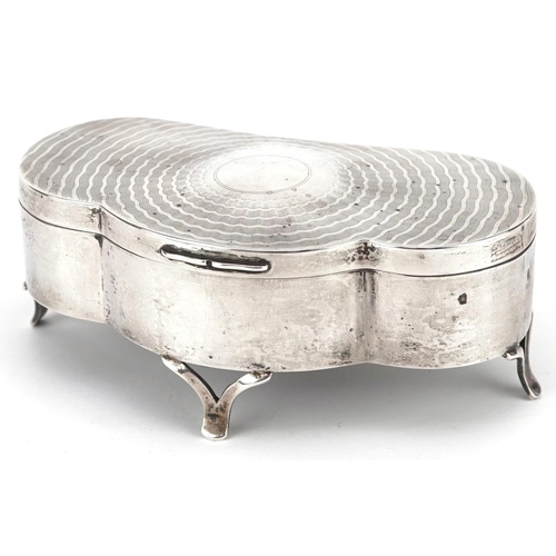 502 - D Bros., an Edwardian shaped silver jewel box raised on three feet having hinged lid and fitted inte... 