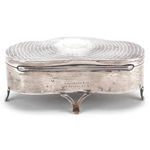 502 - D Bros., an Edwardian shaped silver jewel box raised on three feet having hinged lid and fitted inte... 