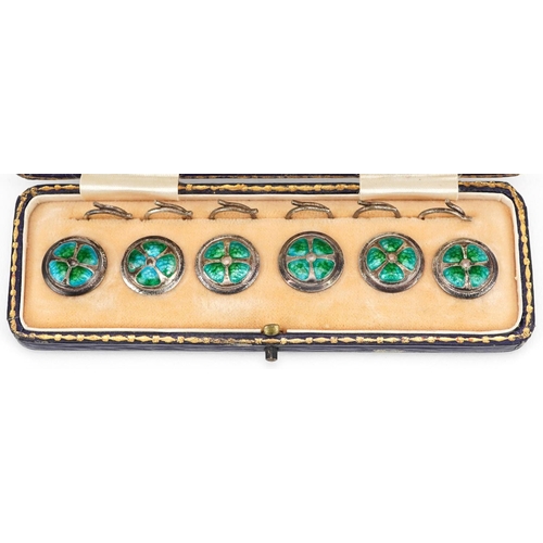  A set of six Arts & Crafts silver and enamel studs housed in a velvet and silk lined fitted case, ea... 