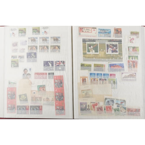 2218 - Red stamp album containing 19th century and later commonwealth stamps, mainly Papua, many cricket re... 