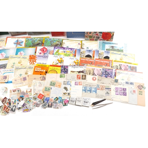 2225 - A quantity of Papua and New Guinea stamps, some arranged in albums, approximately thirty Papua stamp... 