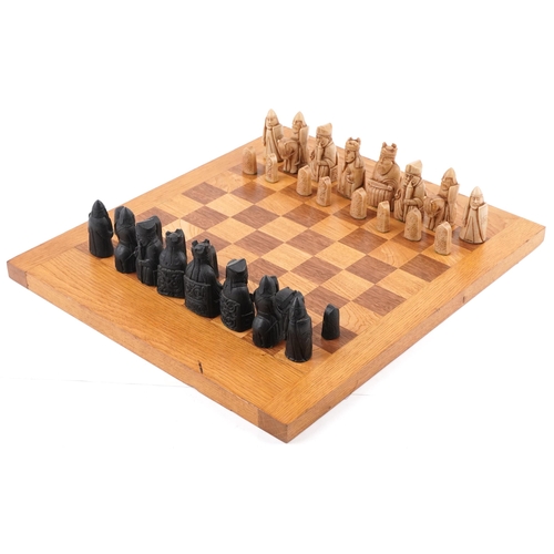 1354 - A late 20th century wax chess set on an oak chequer board, 45cm x 52cm, the king 9cm high.