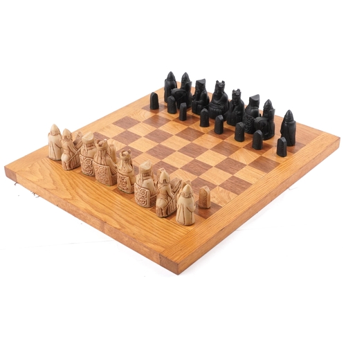 1354 - A late 20th century wax chess set on an oak chequer board, 45cm x 52cm, the king 9cm high.