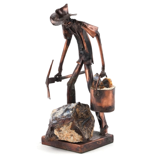 403 - A copper and opal sculpture of an Australian opal miner, indistinctly signed, 21cm high.