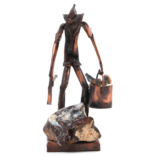 403 - A copper and opal sculpture of an Australian opal miner, indistinctly signed, 21cm high.