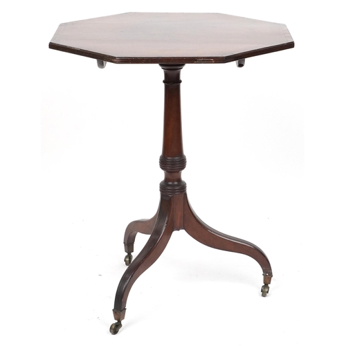 2047 - An early 19th century mahogany octagonal tip top wine table with crossbanded decoration raised on tr... 