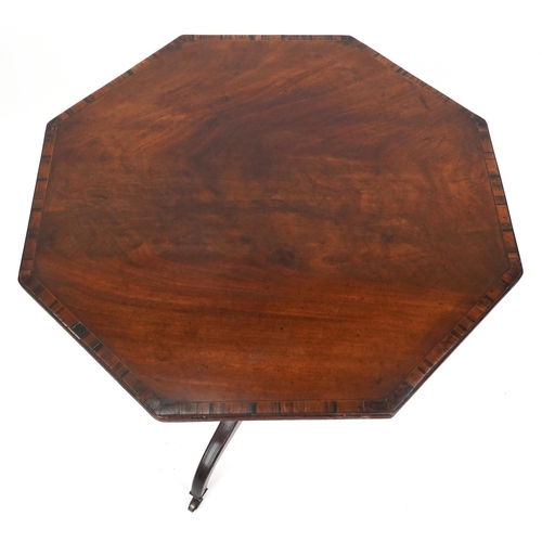 2047 - An early 19th century mahogany octagonal tip top wine table with crossbanded decoration raised on tr... 