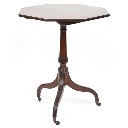 2047 - An early 19th century mahogany octagonal tip top wine table with crossbanded decoration raised on tr... 