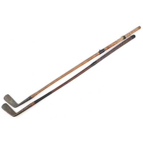 2297 - Two vintage hickory shafted brass headed golf clubs, one by Elverys, 85cm in length.